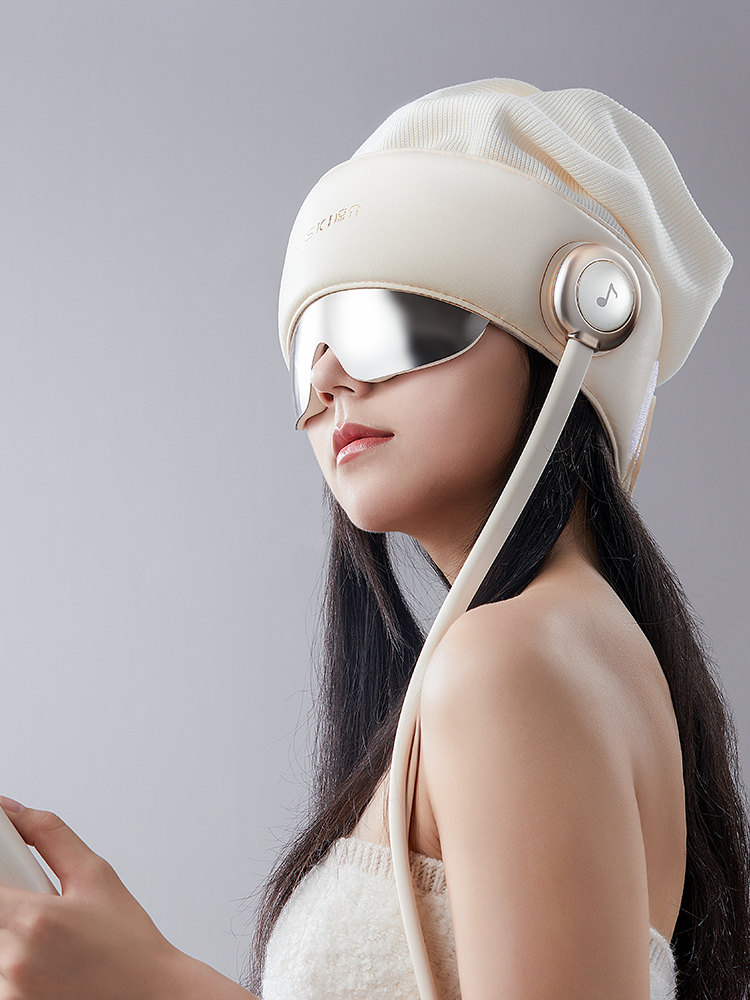 A woman wearing the cream R2 head massager