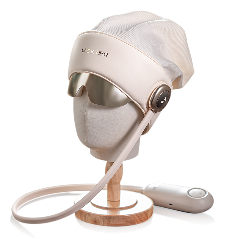 Cream R2 head massager with a silver visor and handheld control